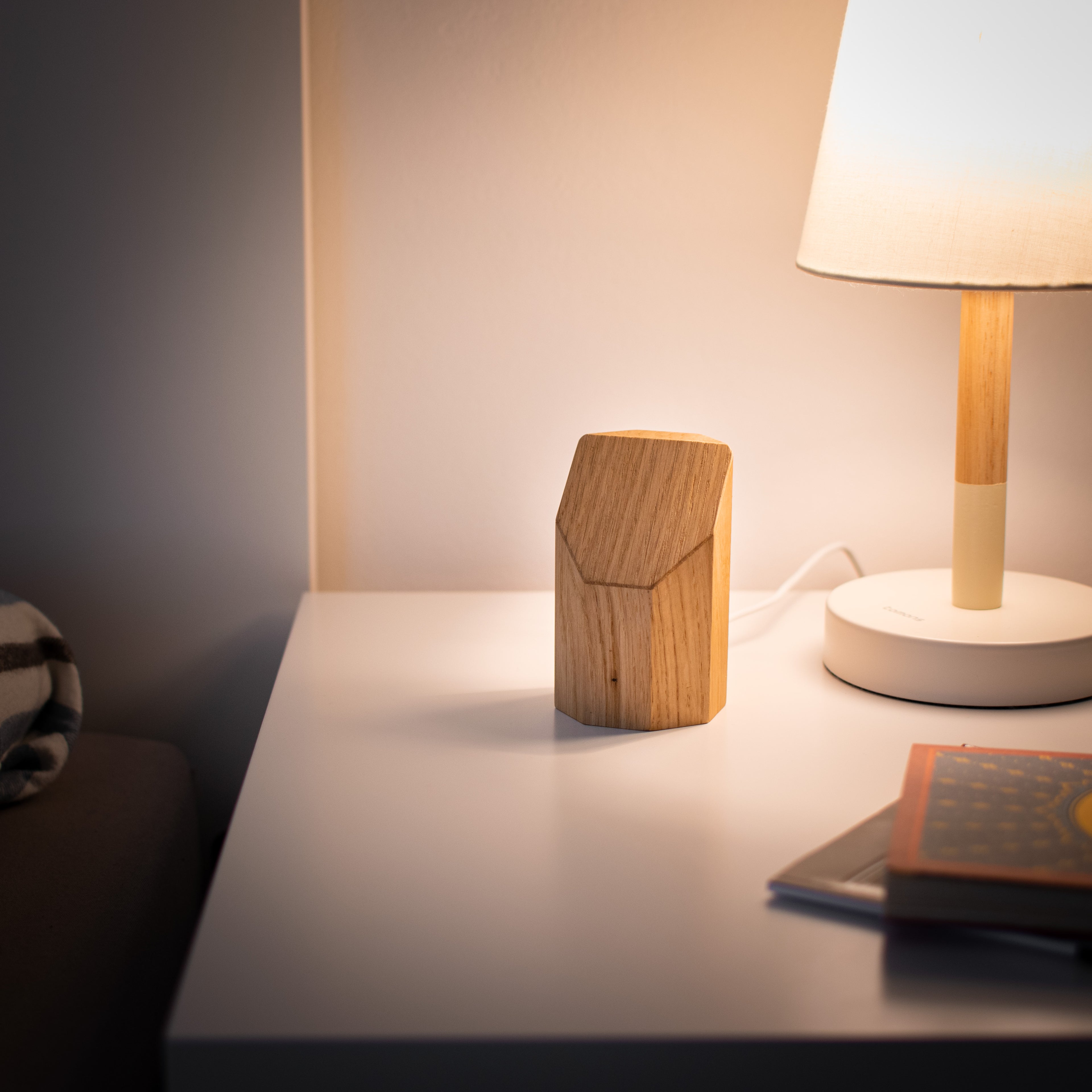 Wooden lampshade on a table with a soft glow