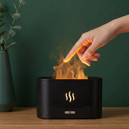 Hand touching adiffuser on a wooden surface with a green background