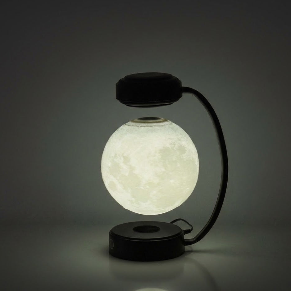 Glowing spherical lamp with a black base and arm on a dark background