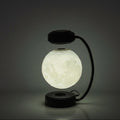 Glowing spherical lamp with a black base and arm on a dark background